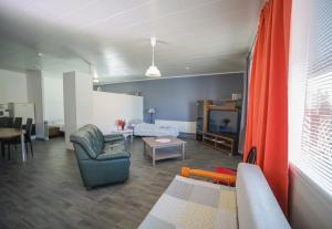 a living room with a couch a chair and a tv at Hostelli Karvia in Karvia