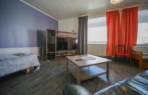 a bedroom with a bed and a table in a room at Hostelli Karvia in Karvia