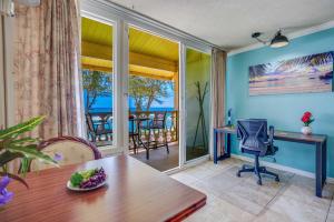 a living room with a table and a desk with a desk at Islander on the Beach 328 in Kapaa