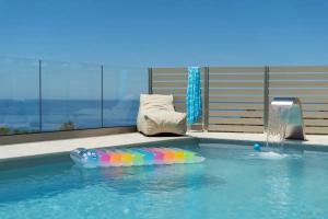 a pool with an inflatable raft in the water at Villa Alia in Sfakiá