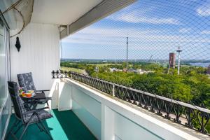 a balcony with two chairs and a view of the city at B-113 Elegantes Meerblick-Apartment in Sierksdorf +16 photos