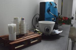 un tavolo con una tazza di caffè e una macchinetta del caffè di Adriano's Rooms a Catania
