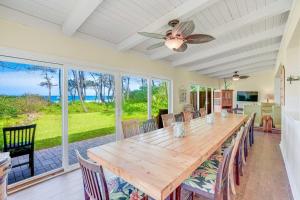 a dining room with a large wooden table and chairs at Anahola Beach House 6br in Anahola