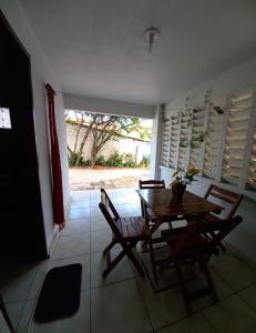 a dining room with a wooden table and chairs at Pousada Triplex Pôr Do Sol in Flecheiras +35 photos