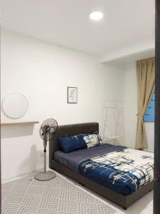 a bedroom with a bed and a fan in it at Irdina HomestayMuslim's at Emerald Avenue Brinchang Centrum in Brinchang