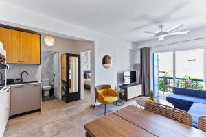 a kitchen and living room with a blue couch at Pasithea SeaView Apartment in Chlorakas