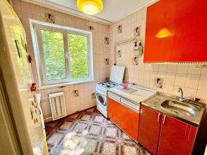 a small kitchen with a sink and a stove at 4rent Two bright bedrooms apartment in Chişinău