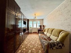 a living room with a couch and a television at 4rent Two bright bedrooms apartment in Chişinău
