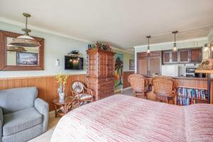 a living room with a bed and a kitchen at Islander on the Beach 152 in Kapaa