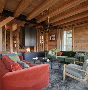 a living room with couches and a fireplace at Valmarélie in Villard-Reculas
