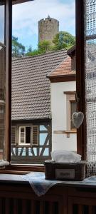 una finestra con vista su un edificio e su un castello di Appartements & Chambres Les Loges du Capucin a Kaysersberg