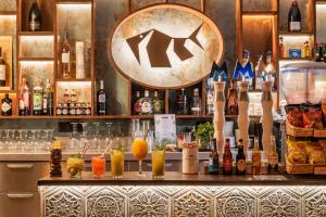 a bar with a bunch of bottles of alcohol at Canyelles Platja in Roses