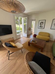 a living room with a couch and a tv at Chez Gilles et Aline in Figeac