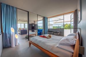 a bedroom with a bed and a large window at La Rotonda - Incredible Méditerranéen and St Tropez view 360! Centre ville 5 mns in Saint-Tropez