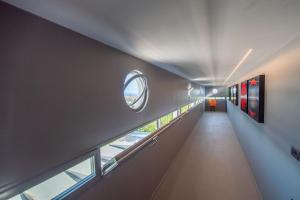 a long hallway with windows and a circular window at La Rotonda - Incredible Méditerranéen and St Tropez view 360! Centre ville 5 mns in Saint-Tropez