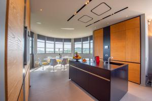 a kitchen with a counter and a table and chairs at La Rotonda - Incredible Méditerranéen and St Tropez view 360! Centre ville 5 mns in Saint-Tropez +20 photos