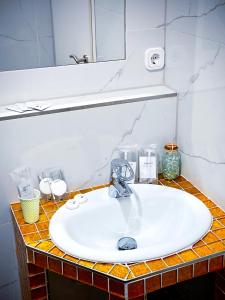 a bathroom counter with a sink and a mirror at Jakz Hotel in Herten +16 photos