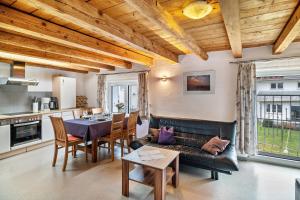 a living room with a couch and a table at Ferienhaus Felicia in Ravensburg +19 photos
