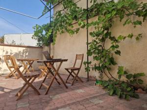 a picnic table and chairs with a laptop on it at Buddha Hostel Bodoni in Chişinău