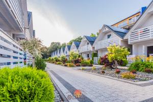 a row of houses on a street at Domki OLIVIA in Darlowko