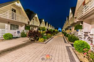 a cobblestone street in front of a row of houses at Domki OLIVIA in Darlowko +33 photos