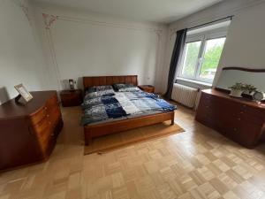 a bedroom with a bed and two dressers and a window at -Self-Check- 4-Room Extra large house in Nitra +18 photos