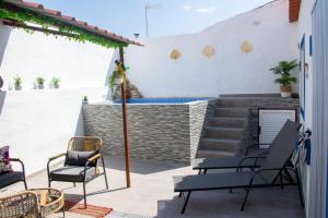 a patio with chairs and a swimming pool at Casa do Poço Azul in Reguengos de Monsaraz