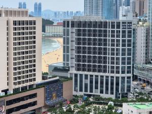 a view of a city with a beach and buildings at Hotel Irua Haeundae in Busan