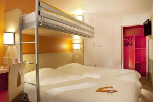 a hotel room with two bunk beds in it at Premiere Classe Pau Est-Bizanos in Pau