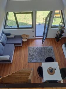 an open living room with a couch and a table at Vikendica na Avali in Donja Ralja