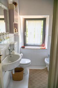 a bathroom with a sink and a toilet and a window at Piccozzo agritour in Casciana Terme +52 photos