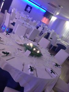 a white table with glasses on it in a room at Hotel La Terrazza in Barletta