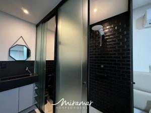 a bathroom with a shower and a sink and a mirror at Get By Side 50 Metros da Praia - Jardim Oceania in João Pessoa