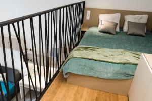 a bedroom with a bed with a green blanket at Széchenyi Center in Szeged