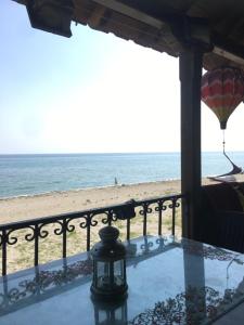 a table with a view of the beach at Ανατολή apartment in Nea Mesangala +17 photos