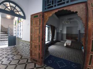 an open door in a room with a couch at Maison De La Lune in Tétouan