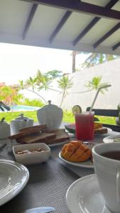 a table with plates of food and cups on it at Ocean View tourist guest house at Negombo beach in Negombo