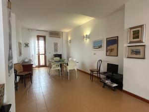 a living room with a table and chairs at NURAS - Penthouse Antonietta with view in Alghero