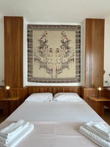 a bedroom with a bed with two towels on it at NURAS - Penthouse Antonietta with view in Alghero