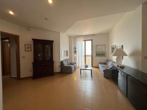 a living room with two chairs and a table at NURAS - Penthouse Antonietta with view in Alghero +14 photos