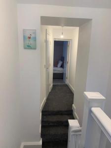 a hallway with a staircase leading to a bedroom at 19 Eyre Square Lane Galway in Galway +1 photo
