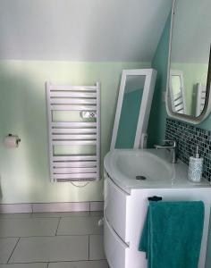 a bathroom with a sink and a mirror at Poulou Pyrénées in Gelos