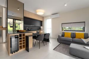 a kitchen and living room with a couch and a table at The Q Bliss - your new 4-star hideaway with a garage in Rovinj