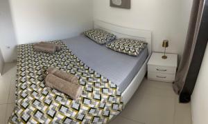 a bedroom with a large bed with two pillows at Apartments AS in Budva