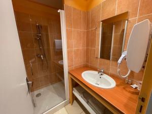 a bathroom with a sink and a shower at Les terrasses du durzon in Nant +22 photos