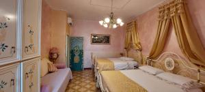 a bedroom with two beds and a chandelier at Bellavista Versilia in Pietrasanta