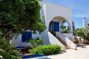 a white house with blue doors and stairs at Villa Casa Madre in San Vito lo Capo