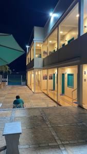 a building with a bench in front of it at night at Voar Pousada in Barreirinhas