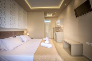 a bedroom with a bed with towels on it at Nastazia Studios in Laganas +23 photos