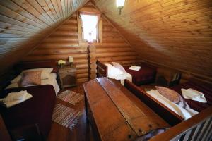 an attic room with two beds and a window at Garić Bajka in Križevci
